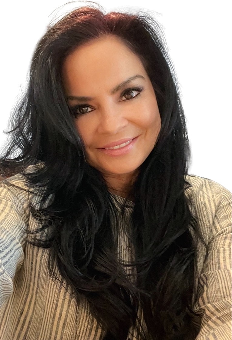 Smiling woman with long black hair, neutral background.